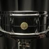 Gretsch 5x14 G4160 Chrome Over Brass. shiny chrome finish on shell and shell hardware. round goldish gretsch badge. grooved line around center of drum. die-cast hoops