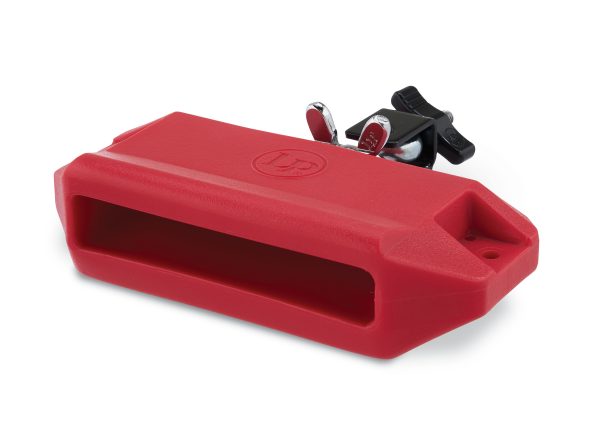 LP Medium Pitch Jam Block LP1207. Red plastic rectangular block with tapered edges and sound hole. black mounting bracket is repositionable. LP logo embossed on top of block