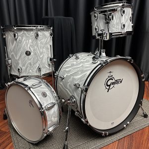 Gretsch Model: CT1-J484-WSF catalina club jazz 4 piece drum set with chrome shell hardware. 12 tom 14 floor tom with legs 18 bass drum with tom holder 14 snare drum. white satin flame swirled textured finish