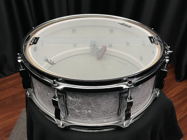 Ludwig Jazz Fest 5.5x14 snare drum in white marine pearl finish. Legacy Mahogany shell. Snare side view.