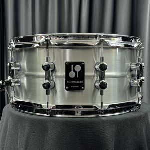 Sonor Kompressor Series six point five by fourteen aluminum shell snare drum from front showing badge