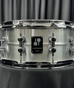 Sonor Kompressor Series six point five by fourteen aluminum shell snare drum from front showing badge