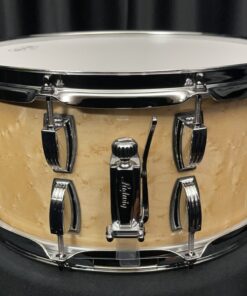 Ludwig classic maple six point five by fourteen snare drum with birdseye inner and outer plies in natural gloss finish showing throw off